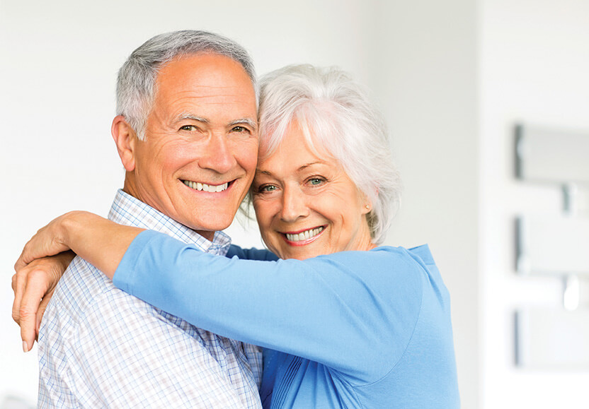 man and woman hugging and smiling
